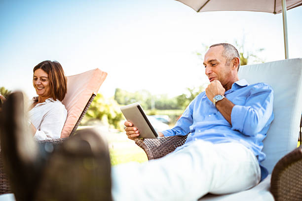 couple relaxing with multimedia device at the resort