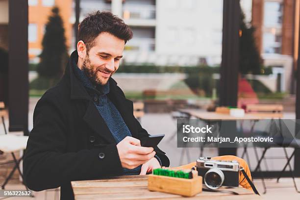 Young Man Texting Stock Photo - Download Image Now - Adult, Asking, Bar - Drink Establishment