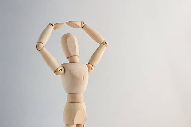 istock wood figure  creating a roof over his head 516323316