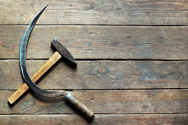 Background of hammer and sickle on old wooden floor stock photo