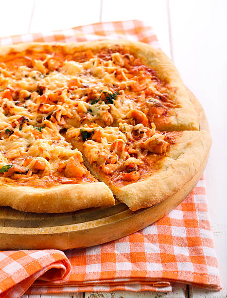 istock Salmon and herb pizza on board 516325116
