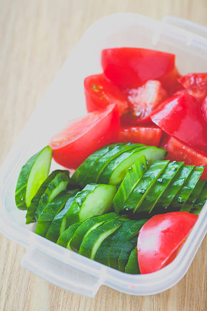 istock Slice cucumber  and slice tomato in plastic lunch box 516325620