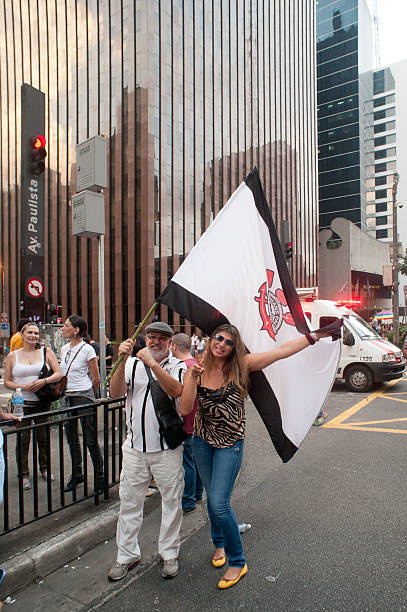 Pro-Government Protesters in Brazil São Paulo, Brazil - March 18, 2016: Fans of a popular Brazilian soccer team favorable to the government promote act on Paulista Avenue denouncing an alleged coup attempt by the rightist opposition. corinthians fc stock pictures, royalty-free photos & images