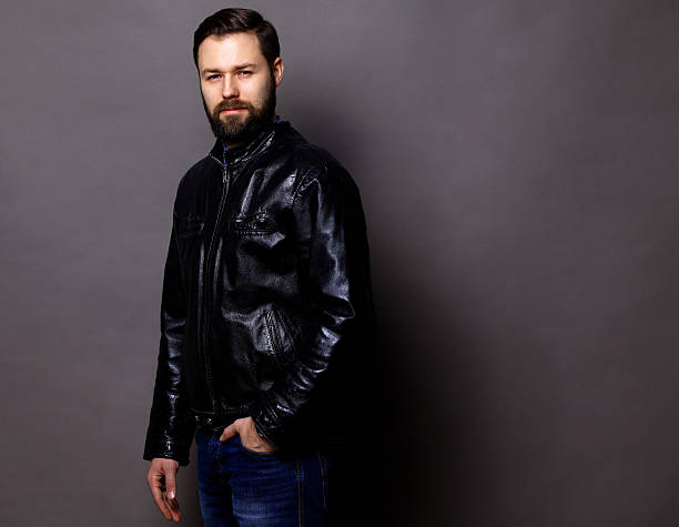 istock Attractive Young Man Wearing Leather Jacket on gray 516327022