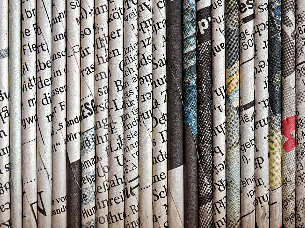 rolled up newspaper pages stock photo