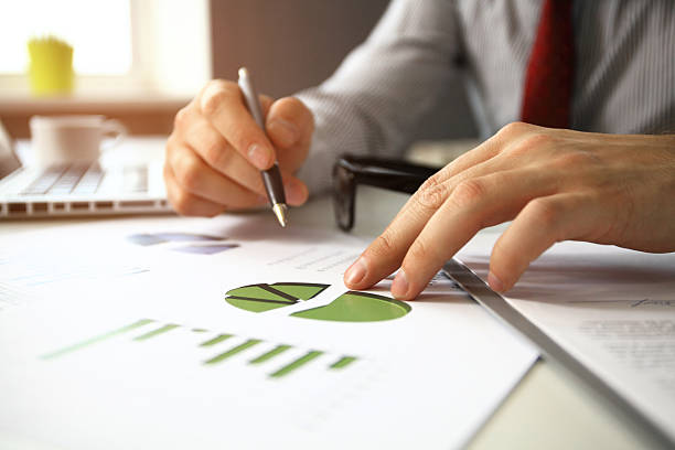 istock male hand pointing at business document during discussion at meeting 516328212