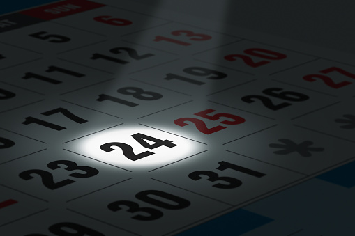 Illustration of calendar with a spot lit date in focus.