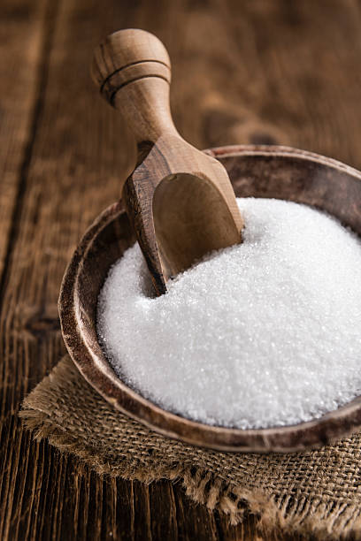 istock White Sugar (selective focus) on wooden background 516328922