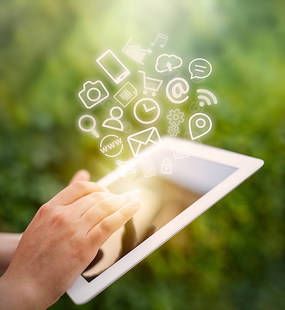 istock female hand touching tablet computer screen and app icons fly 516330942