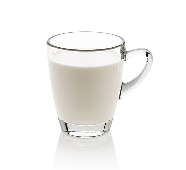 istock Glass of milk isolated on white 516331030