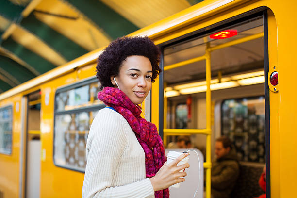 istock Happy young woman boarding a train 516331270