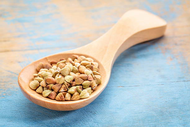 istock buckwheat grain on wooden spoon 516331810
