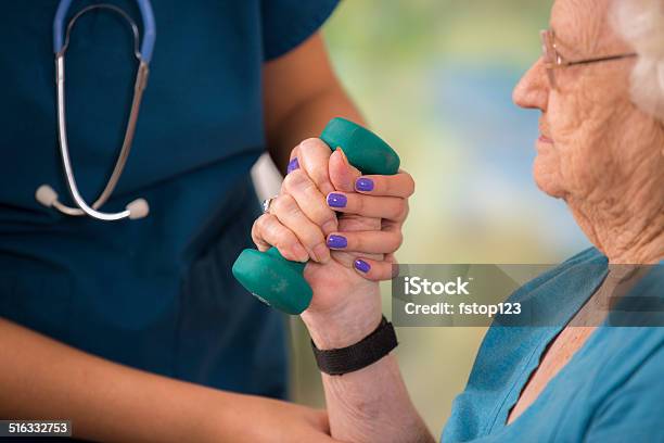 Nurse Does Physical Therapy With Senior Woman Patient Arm Strengthening Stock Photo - Download Image Now