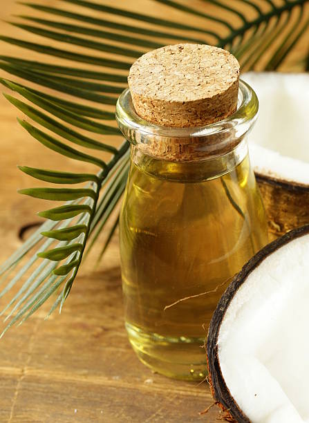 istock coconut oil in a glass bottle and fresh nuts 516333277