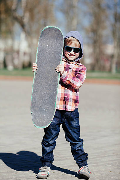 istock little boy with skateboard on the street 516335451