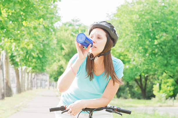 istock Tired female cyclist stopped to catch a breath. 516335877