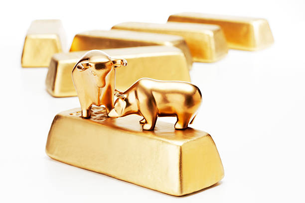 istock Golden bull bear figurine on gold bars 516336005