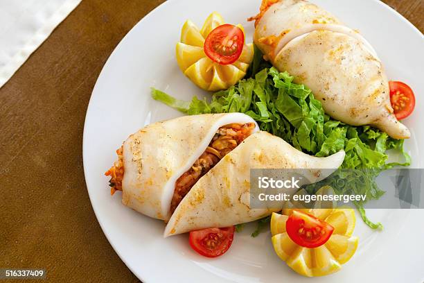 Squid Stuffed With Seafood In White Plate On Wooden Table Stock Photo - Download Image Now