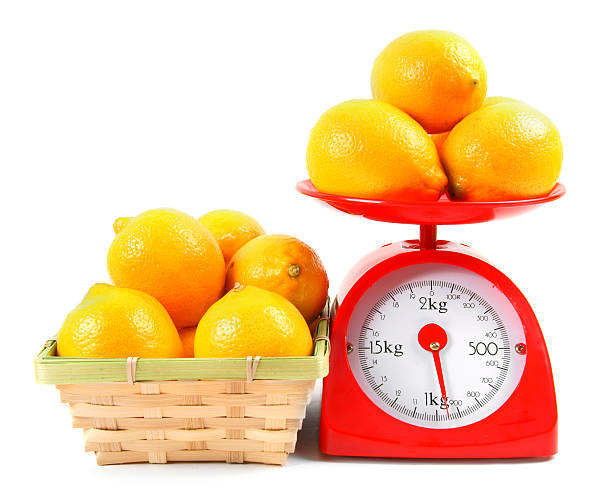 istock Lemons on scales and in a basket. 516337941
