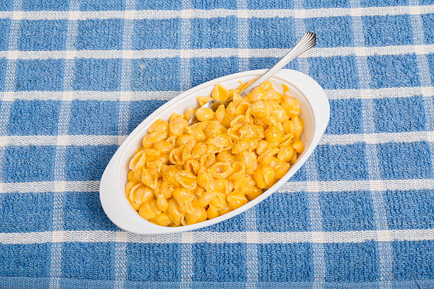 istock Macaroni and Cheese with Fork on Blue Placemat 516338365