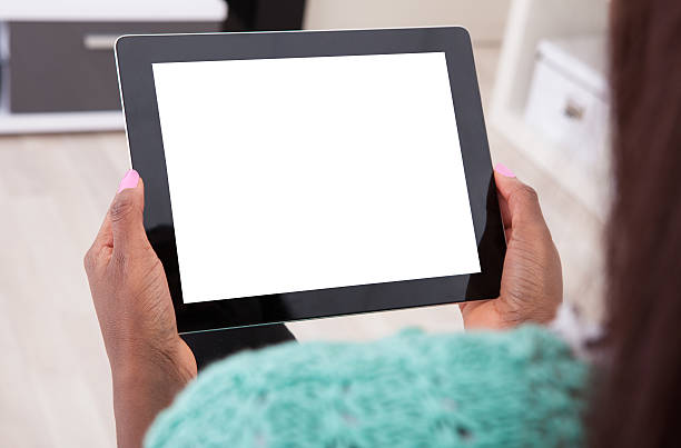 istock Woman Holding Digital Tablet At Home 516338437