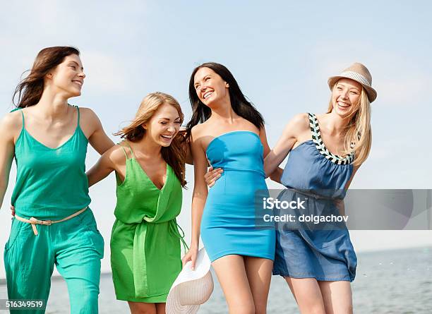 Smiling Girls Walking On The Beach Stock Photo - Download Image Now - Dress, Women, Teenage Girls