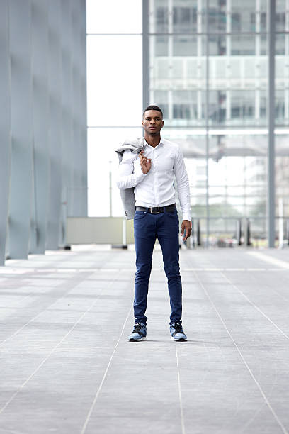 istock Trendy young man standing in building alone 516349627