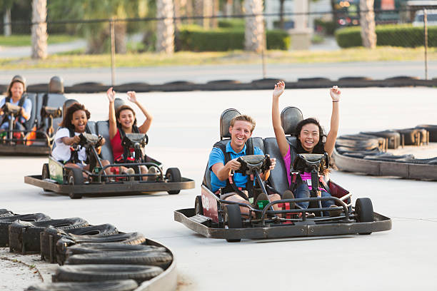 istock Group of teens riding go carts 516351033