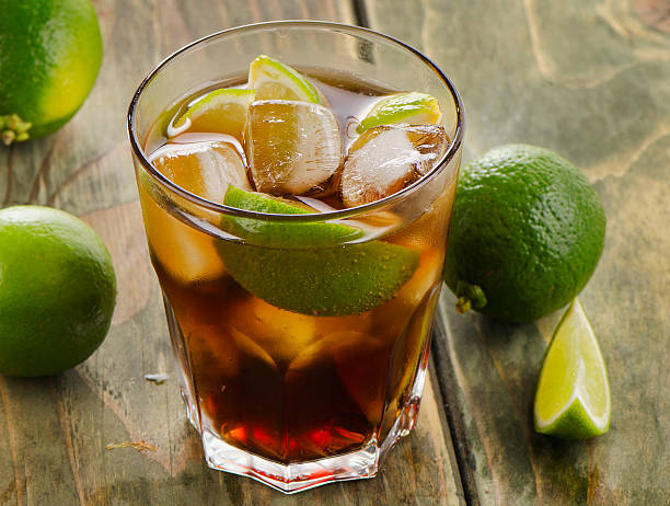 istock Cuba Libre cocktail with limes on a wooden 516351209