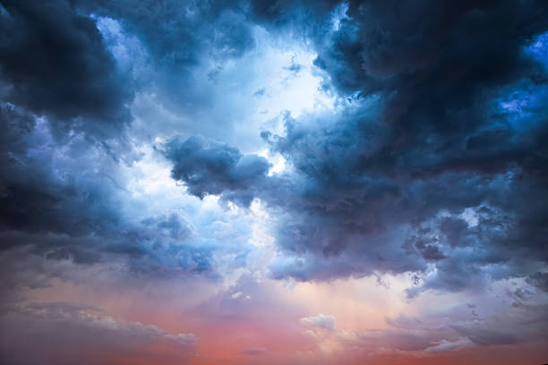 Majestic Storm Clouds Beautiful storm clouds on a summer night with pinks and blues. moody sky stock pictures, royalty-free photos & images