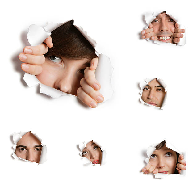 istock Multiethnic people looking through ripped paper holes 516353243
