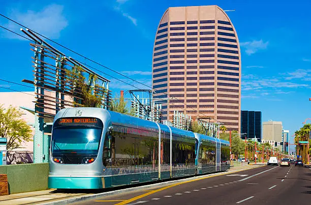 Phoenix Metro Light Rail Train with Midtown Phoenix buildings in the background.