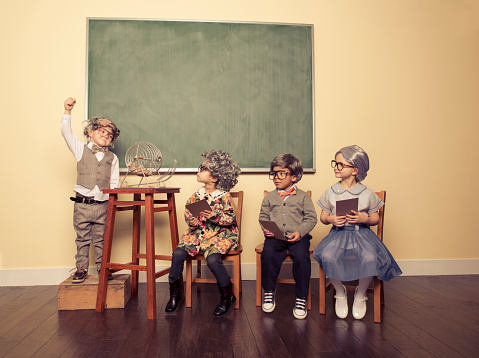 The winning number is. . . A group of kids dressed up as senior citizens have fun with a game of Bingo. 