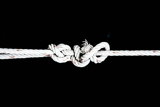 istock knot of white rope on black isolate 516354643