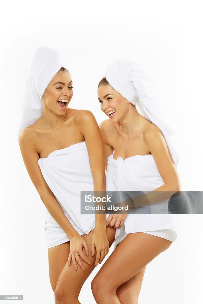 Two happy teenage girls after showering in towels. Two teenage girls after showering in towels Adult Stock Photo