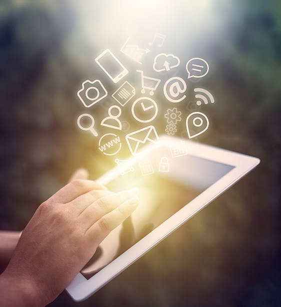 istock female hand touching tablet computer screen and app icons fly 516356108