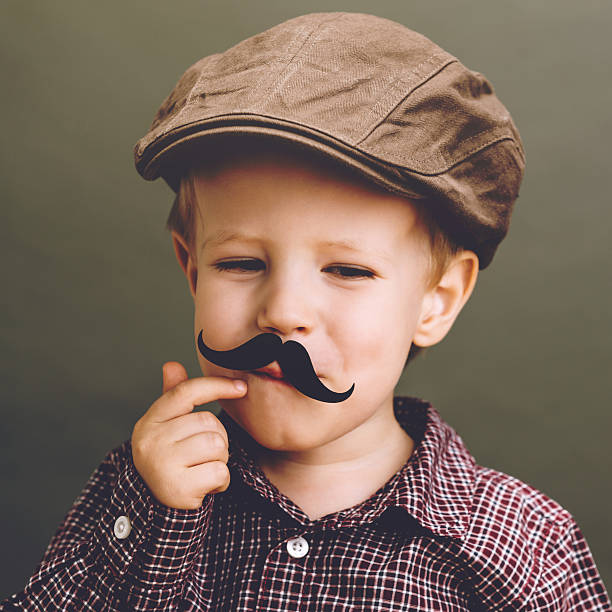 istock Little smiling boy with a paper Mustache 516356179