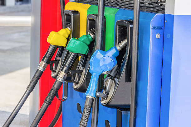 istock Gas pump nozzles in a service station 516356636