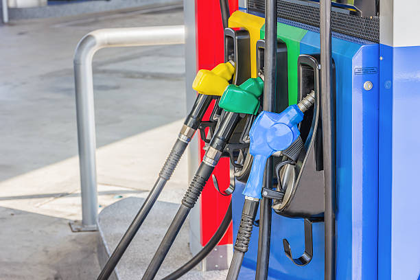 istock Gas pump nozzles in a service station 516356964