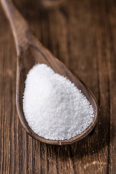 istock White Sugar (selective focus) on wooden background 516358222