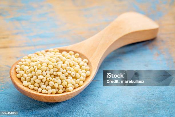 Millet Grain On Wooden Spoon Stock Photo - Download Image Now - Blue, Food, Food and Drink