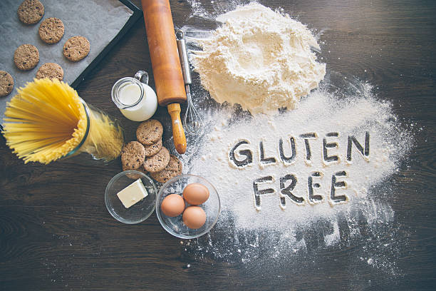 Baking background with "Gluten free" writting in flour Baking background with "Gluten free" writting in flour wholegrain flour stock pictures, royalty-free photos & images