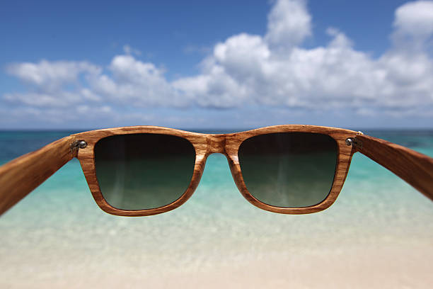 View through wooden sunglasses into tropical beach of Philippines