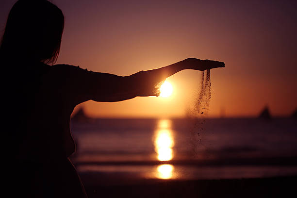 istock Woman pouring sand 516361546