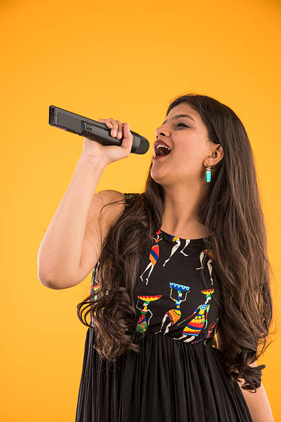 istock beautiful Indian singer with a mic in her hand 516364104