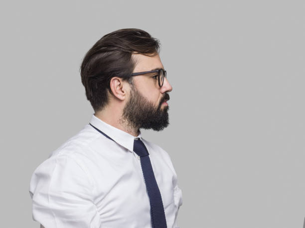 Portrait of businessman over isolated gray background. Horizontal composition, studio shot. Image taken with Hasselblad H5D 50C developed from camera RAW.