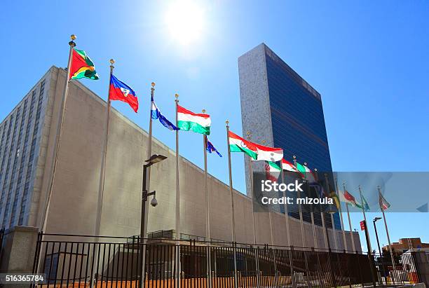 United Nations Headquarters With Waving Flags In New York Usa Stock Photo - Download Image Now