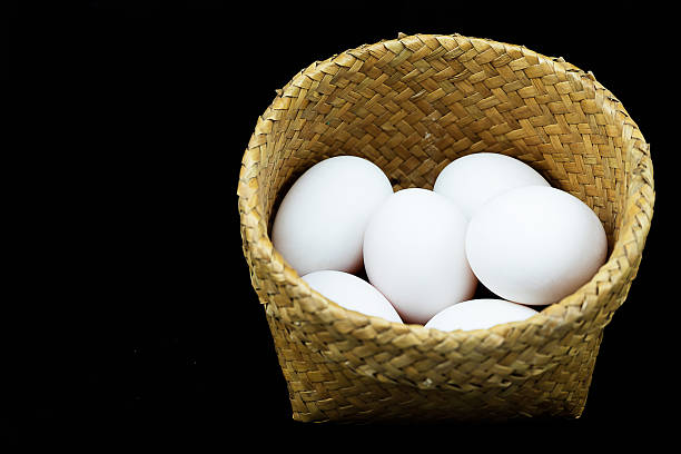 istock Basket of Duck eggs isoated on black background, Bamboo Containe 516366550