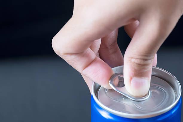 istock Finger opening a blue can, isolated on black background 516366630