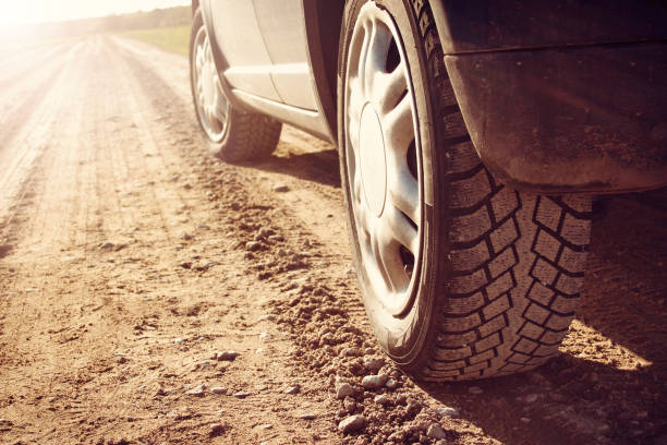 istock car tire on dirt road 516367274